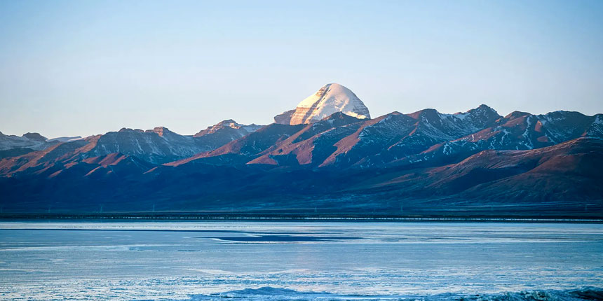 Mount Kailash with the serene Lake Manasarovar in Tibet, a sacred pilgrimage site for Hindus, Buddhists, Jains, and Bon followers.