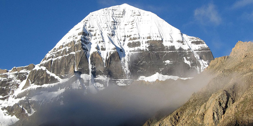 Close view of the sacred Mount Kailash peak covered with snow and surrounded by mist in Tibet, revered in Kailash Mansarovar Yatra
