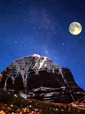 Night view of Mount Kailash with the full moon and starry sky above the snow-capped peak