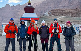 Group of trekkers standing in front of a stupa during the Mount Kailash trek in Tibet