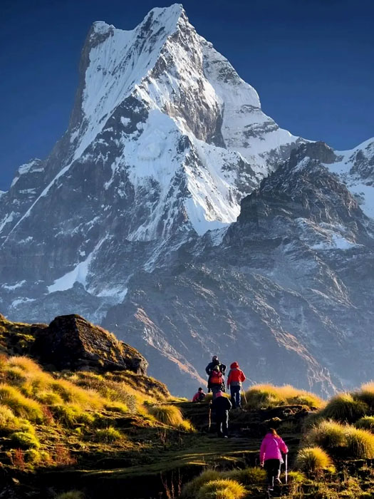 Trekker walking toward Everest Base Camp with views of the Khumbu Icefall and Himalayan peaks